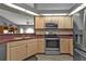Updated kitchen featuring stainless appliances and light wood cabinetry at 25202 Chiclayo Ave, Punta Gorda, FL 33983
