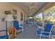 Inviting screened-in patio with multiple seating areas and views of the beautifully landscaped backyard at 25202 Chiclayo Ave, Punta Gorda, FL 33983