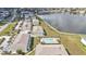 Aerial view of the homes beside a lake, featuring a community pool with seating at 26300 Rampart Blvd # 404, Punta Gorda, FL 33983