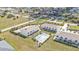 Aerial view showcasing the community pool and surrounding homes with manicured lawns at 26300 Rampart Blvd # 404, Punta Gorda, FL 33983