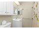 Bathroom with white vanity, cabinet, and framed mirror at 26300 Rampart Blvd # 404, Punta Gorda, FL 33983
