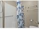 Bathroom shower with seashell-themed curtain and grab bars at 26300 Rampart Blvd # 404, Punta Gorda, FL 33983
