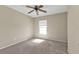 Bright bedroom with neutral carpet and a ceiling fan at 26300 Rampart Blvd # 404, Punta Gorda, FL 33983
