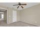 Bedroom with neutral carpet, ceiling fan, and water-view balcony access at 26300 Rampart Blvd # 404, Punta Gorda, FL 33983