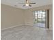 Bedroom featuring tile flooring and a sliding glass door to a sunroom at 26300 Rampart Blvd # 404, Punta Gorda, FL 33983