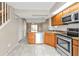 Open kitchen featuring stainless steel appliances and tile flooring at 26300 Rampart Blvd # 404, Punta Gorda, FL 33983