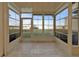 Screened-in lanai with tile floor, sliding glass door, and beautiful lake view at 26300 Rampart Blvd # 404, Punta Gorda, FL 33983