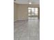 Living room featuring tile flooring and a sliding glass door to a sunroom at 26300 Rampart Blvd # 404, Punta Gorda, FL 33983