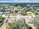 Residential street with well-maintained homes and lush landscaping, as seen from an aerial perspective at 2822 Logsdon St, North Port, FL 34287