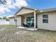 Backyard view featuring a covered patio, outdoor seating, and a well-maintained lawn at 2822 Logsdon St, North Port, FL 34287