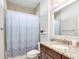 Bathroom featuring a granite countertop, vanity and a shower behind a patterned curtain at 2822 Logsdon St, North Port, FL 34287