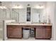 Bathroom with double vanity, granite countertop, decorative cabinet and a shower behind glass doors at 2822 Logsdon St, North Port, FL 34287