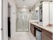 Bright bathroom featuring a glass shower, granite countertop, and dark wood cabinets at 2822 Logsdon St, North Port, FL 34287
