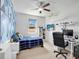 Bedroom with a blue accent wall, a plaid comforter and a computer desk at 2822 Logsdon St, North Port, FL 34287