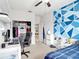 Well-lit bedroom with a patterned accent wall and a view into the dining room at 2822 Logsdon St, North Port, FL 34287