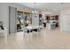 Bright dining area with access to the outdoor patio and views into the modern kitchen with granite countertops at 2822 Logsdon St, North Port, FL 34287