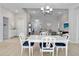 Bright dining area features tile flooring and a modern chandelier at 2822 Logsdon St, North Port, FL 34287