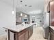 Kitchen featuring island with white granite counters and dark cabinets at 2822 Logsdon St, North Port, FL 34287