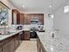 Spacious kitchen featuring stainless appliances, white backsplash, and dark wood cabinets at 2822 Logsdon St, North Port, FL 34287