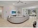 Spacious living area with a large sectional sofa, tile flooring, and access to the dining area and outdoor patio at 2822 Logsdon St, North Port, FL 34287