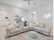 Inviting living room with a comfortable sectional sofa, colorful rug, and stylish decor at 2822 Logsdon St, North Port, FL 34287