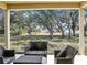 Outdoor patio seating area offering a relaxing space with views of the spacious, tree-filled backyard at 2822 Logsdon St, North Port, FL 34287