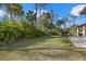 Large backyard with lush landscaping and manicured lawn, perfect for outdoor activities at 3049 Seth Rd, North Port, FL 34288