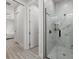 Modern bathroom featuring a marble-tiled walk-in shower with sleek black hardware and glass door at 3049 Seth Rd, North Port, FL 34288