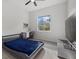 Bedroom with a modern bed, study desk, ceiling fan, and a large window at 3049 Seth Rd, North Port, FL 34288
