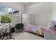 Cozy bedroom featuring a floral quilt, large window, wardrobe, and a comfortable chair at 3049 Seth Rd, North Port, FL 34288