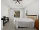Bright bedroom with a comfortable bed, keyboard, ceiling fan, and sliding glass doors at 3049 Seth Rd, North Port, FL 34288