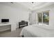 Bright bedroom featuring a work area, keyboard, ceiling fan, and sliding glass doors at 3049 Seth Rd, North Port, FL 34288