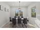 Bright dining room features a modern chandelier, large windows, and stylish decor at 3049 Seth Rd, North Port, FL 34288
