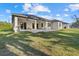 Beautiful home exterior featuring covered patio, manicured lawn, and lush landscaping at 3049 Seth Rd, North Port, FL 34288