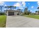 Exterior view of home featuring a modern design, two-car garage, and manicured lawn at 3049 Seth Rd, North Port, FL 34288