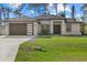 Beautiful single-story home with a modern facade, well-manicured lawn, and a two-car garage at 3049 Seth Rd, North Port, FL 34288