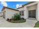 Close up of a house with a two-car garage, front lawn with a garden at 3049 Seth Rd, North Port, FL 34288