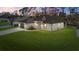 Beautiful single-Gathering home with large front lawn at dusk at 3049 Seth Rd, North Port, FL 34288