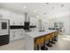 Bright kitchen boasts an oversized island with breakfast bar and pendant lighting at 3049 Seth Rd, North Port, FL 34288