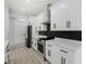 Modern kitchen with white cabinets, quartz countertops, and stainless steel appliances at 3049 Seth Rd, North Port, FL 34288