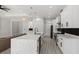 Kitchen island overlooks the electric fireplace and adjacent rooms at 3049 Seth Rd, North Port, FL 34288