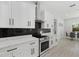 Modern kitchen with white cabinets, quartz countertops, and stainless steel appliances at 3049 Seth Rd, North Port, FL 34288