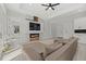 Bright living room features an electric fireplace, TV and sectional sofa at 3049 Seth Rd, North Port, FL 34288