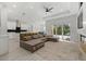 Open-concept living space featuring modern furnishings, a large sofa, and ample natural light at 3049 Seth Rd, North Port, FL 34288