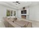 Contemporary living room with a sleek entertainment center, fireplace, and sliding glass doors at 3049 Seth Rd, North Port, FL 34288
