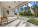 Inviting covered patio featuring ceiling fan and view of the backyard at 3049 Seth Rd, North Port, FL 34288