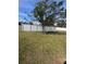 Spacious fenced backyard with a mature tree that provides shade for outdoor seating at 3289 Pellam Blvd, Port Charlotte, FL 33948