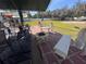 Brick patio with seating area, fire pit, and green lawn at 3289 Pellam Blvd, Port Charlotte, FL 33948