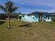 Turquoise home exterior with statue decorations and well-kept lawn at 3289 Pellam Blvd, Port Charlotte, FL 33948