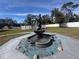 Backyard water fountain surrounded by a stone base with decorative glass and landscaping at 3289 Pellam Blvd, Port Charlotte, FL 33948